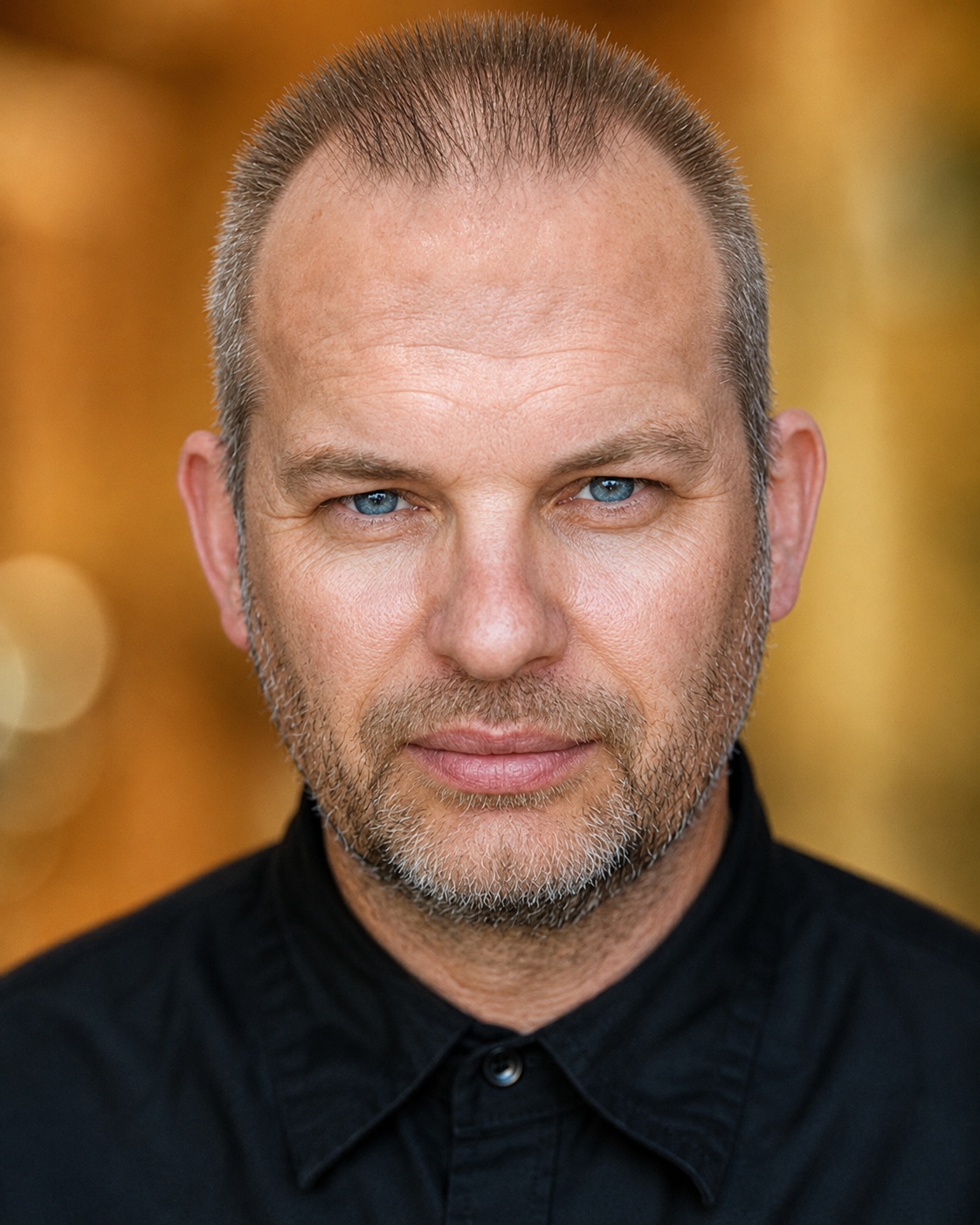 Close portrait of Phil Gwilliam in a black shirt
